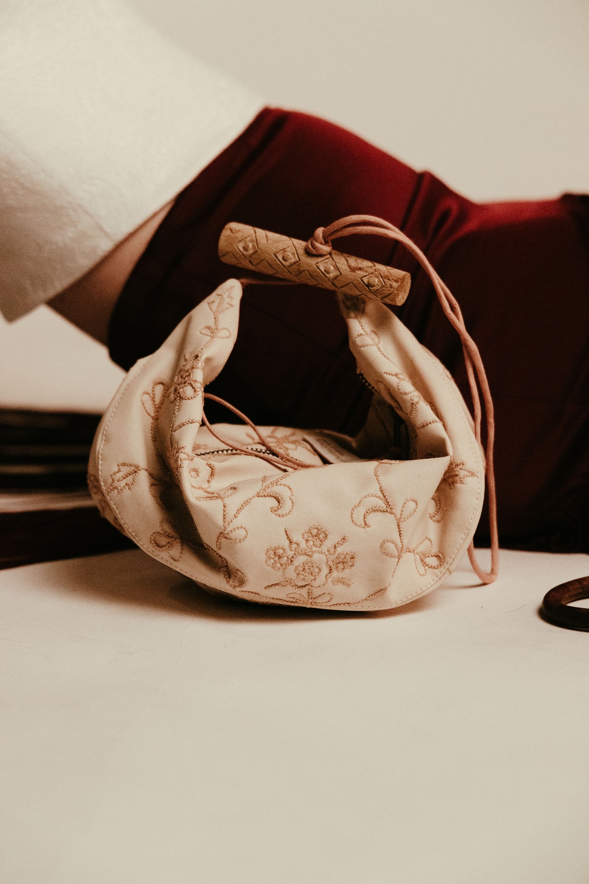 Tie knot embroidered banana leather bag